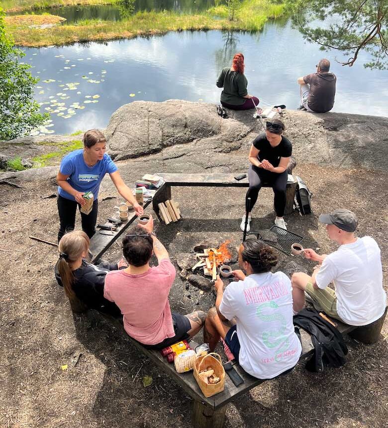 people having a break by the campfire in nuuksio national park