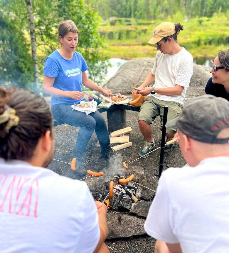 people cooking over a campfire in nuuksio national park